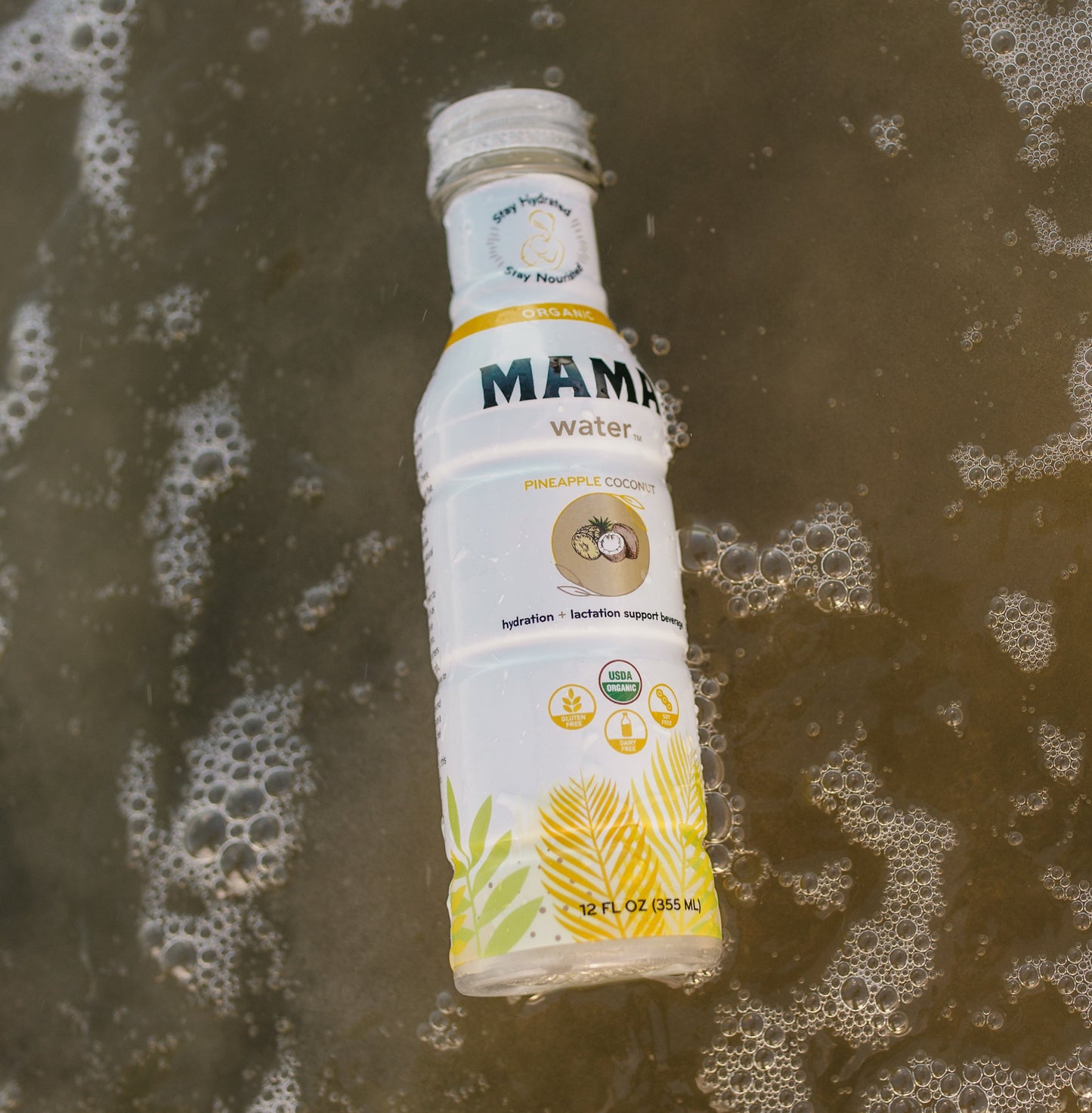 Mama water bottle on a wet surface with foam